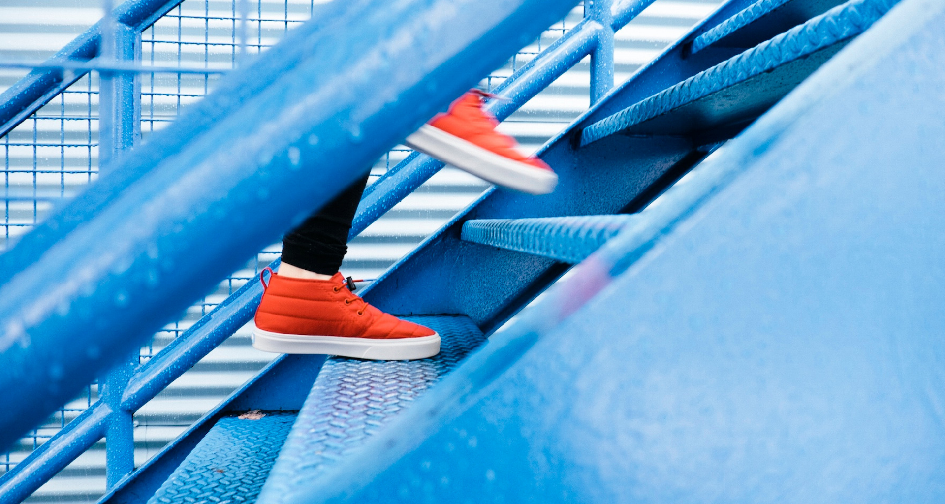 view of person walking up brightly colored stairs