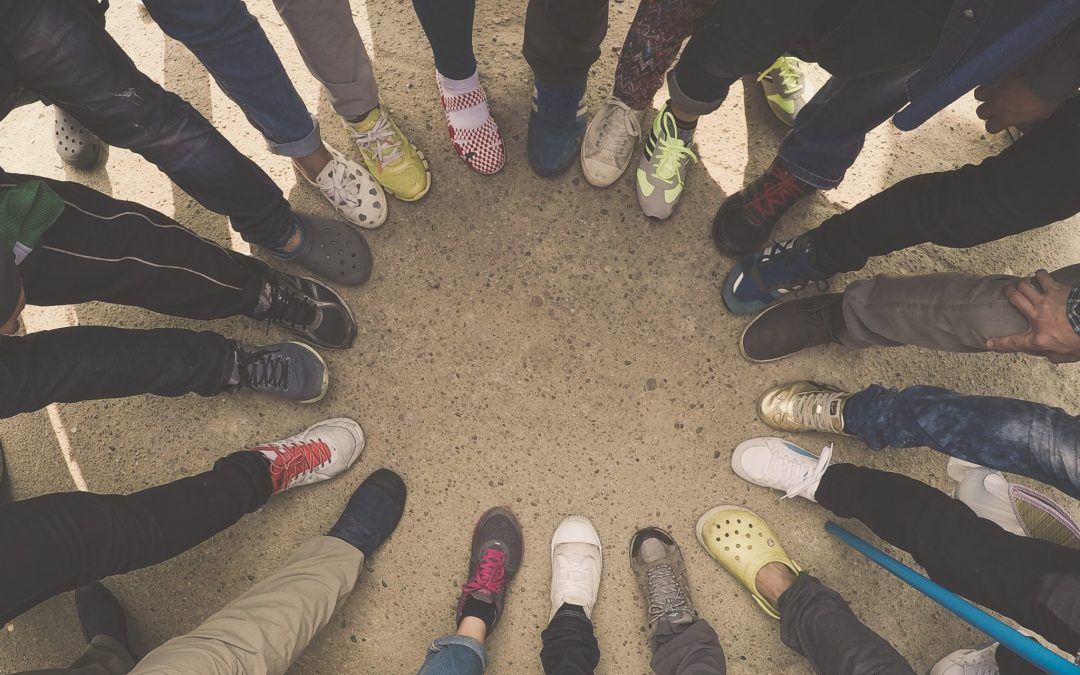 Group of people putting their feet in a circle