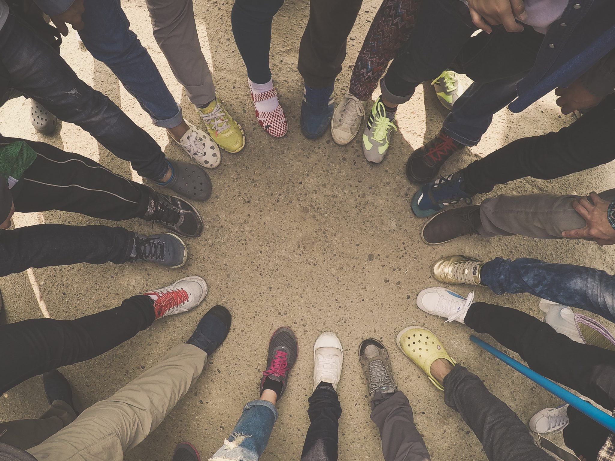 Group of people putting their feet in a circle