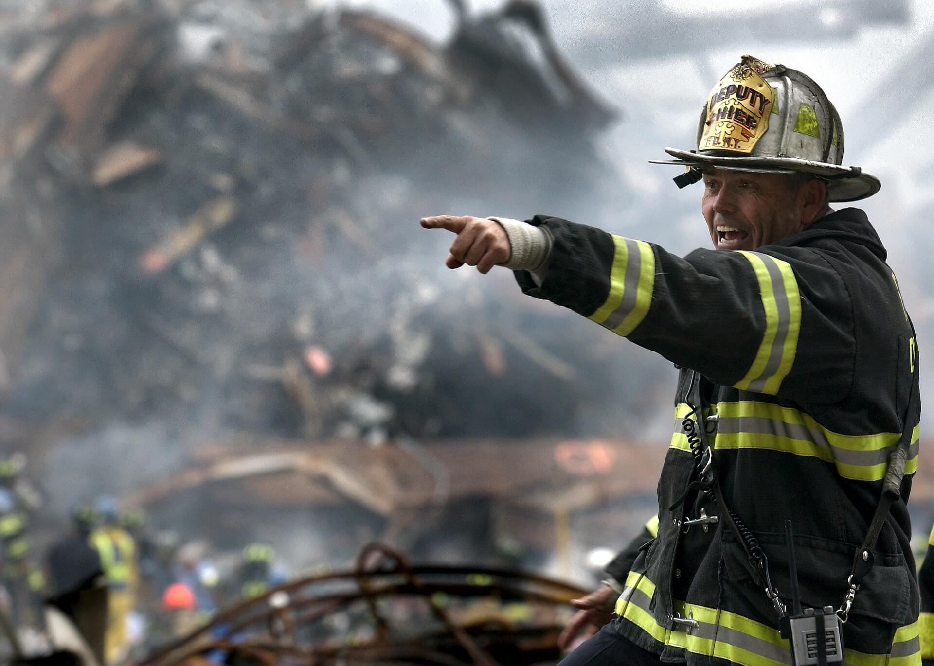 fireman standing in wreckage giving command