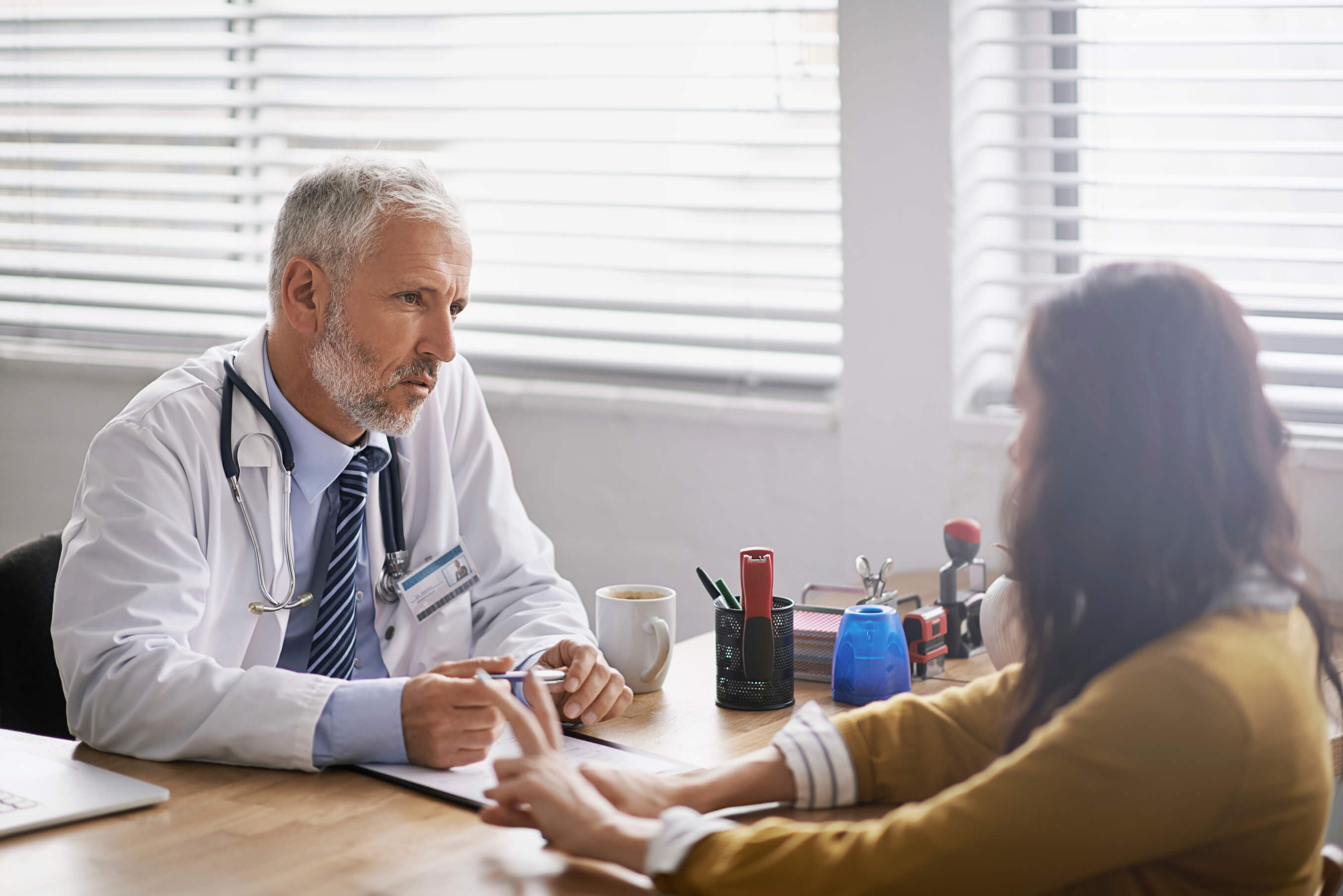 older male doctor speaking to patient