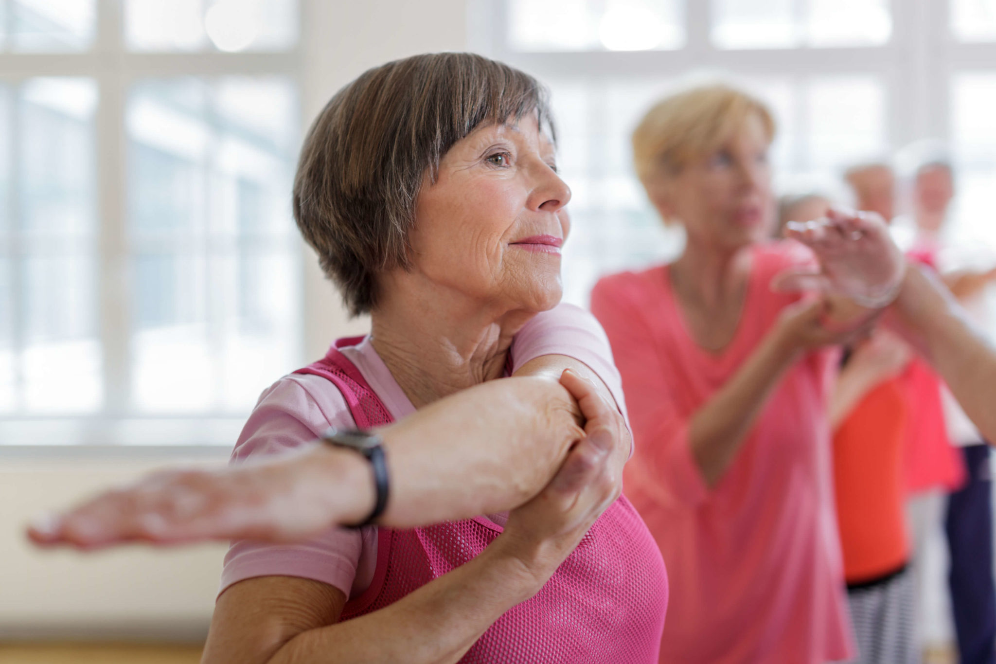 older women stretching in a workout class